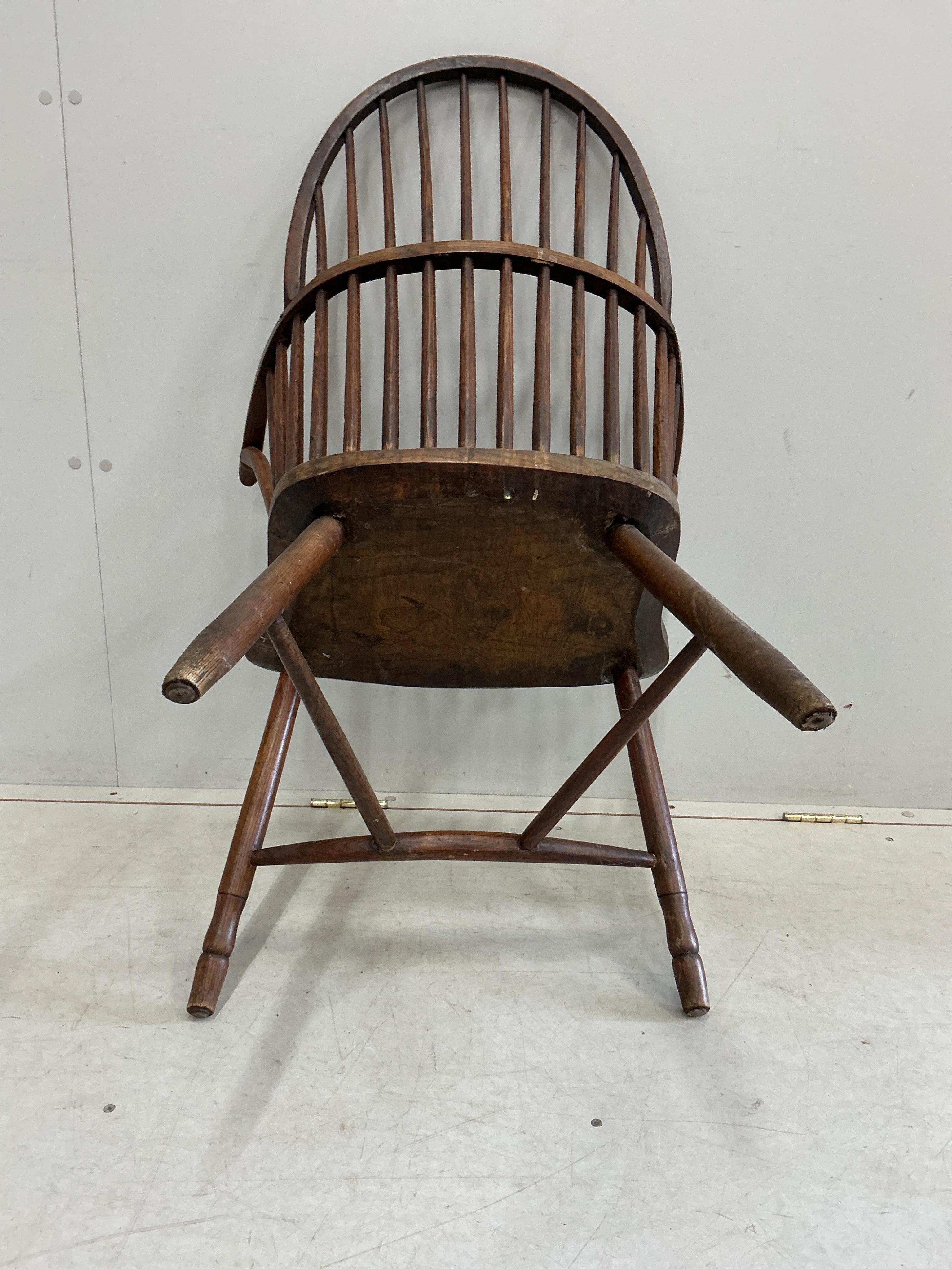 An early 19th century West Country ash and elm Windsor comb back elbow chair, width 57cm, depth 40cm, height 94cm